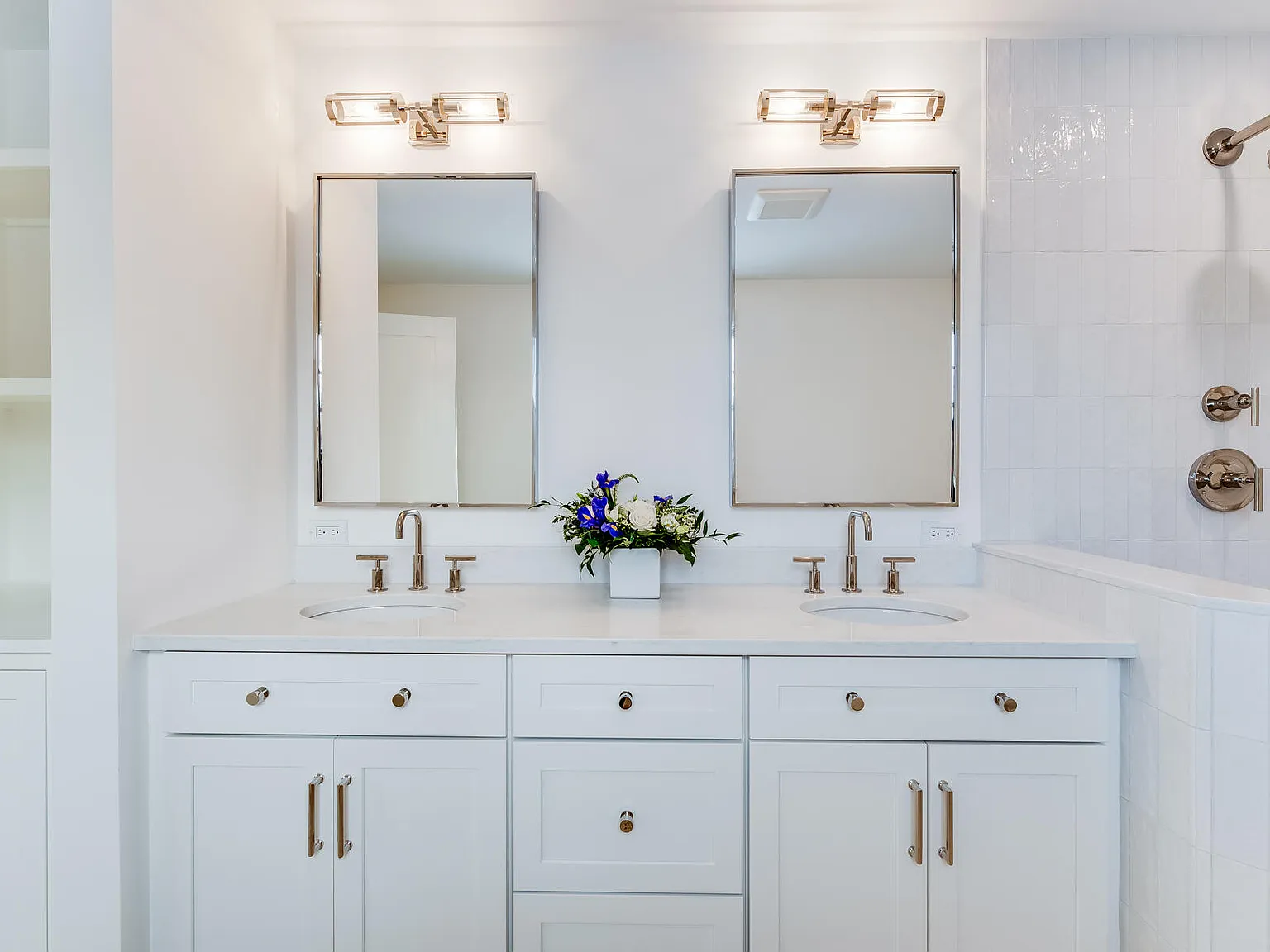 Primary bath double vanity — custom cabinetry, crystal sconces, nickel hardware, Willow Interiors design